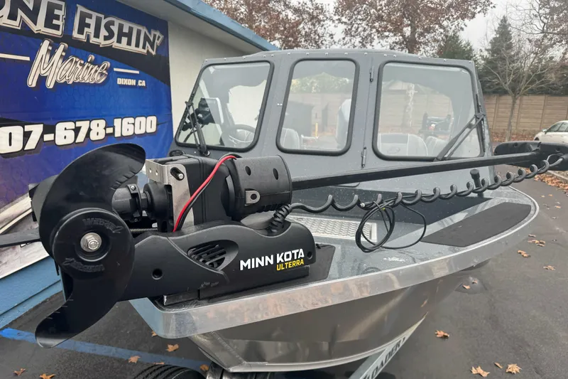 Slide: The Image of 2022 Duckworth 18 Advantage Sport boat with Minn Kota Ulterra motor, parked outdoors. - 4