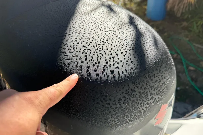 Slide: The Image of Finger pointing at dew-covered surface of 2002 Fishmaster 212 Travis Edition boat. - 10