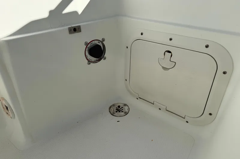 Slide: The Image of 2002 Fishmaster 212 Travis Edition boat interior with hatch and control panel. - 13