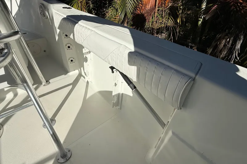 Slide: The Image of 2002 Fishmaster 212 Travis Edition boat interior with padded seating and metal fixtures. - 15