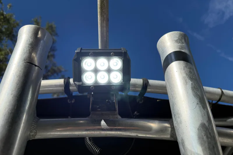 Slide: The Image of LED light on Fishmaster 212 Travis Edition boat, 2002 model, against clear blue sky. - 18