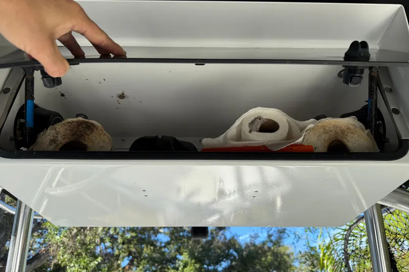 Slide: The Image of Open storage compartment on 2002 Fishmaster 212 Travis Edition boat, containing paper towels. - 19
