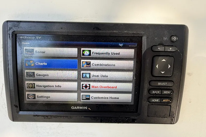 Slide: The Image of Garmin marine GPS display showing navigation options on Fishmaster 212 Travis Edition, 2002 model. - 23