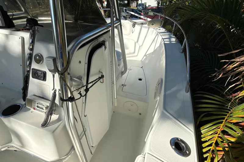 Slide: The Image of 2002 Fishmaster 212 Travis Edition boat interior with control panel and seating area. - 24