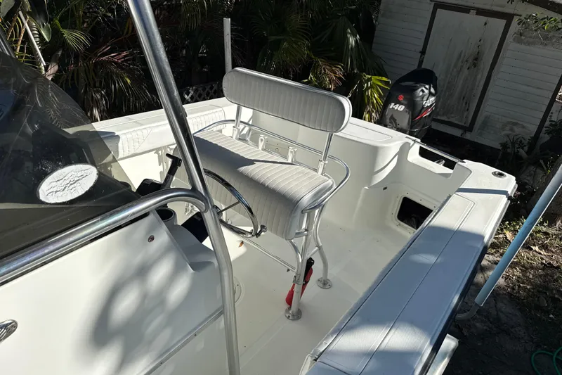 Slide: The Image of 2002 Fishmaster 212 Travis Edition boat interior with seating and Suzuki 140 outboard motor. - 33