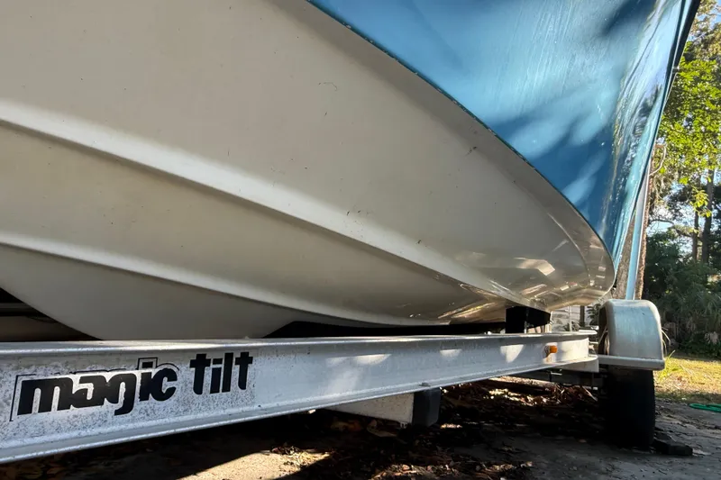 Slide: The Image of 2002 Fishmaster 212 Travis Edition boat on Magic Tilt trailer, side view. - 5