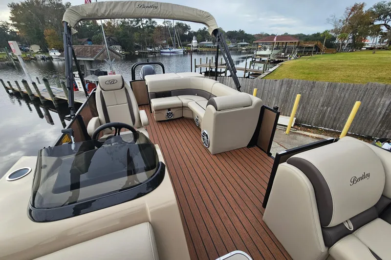 Slide: The Image of 2026 Bentley Pontoons Legacy 243 Cruise with luxurious seating and sleek design on a scenic dock. - 11