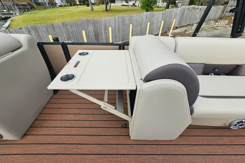 Slide: The Image of 2026 Bentley Pontoons Legacy 243 Cruise interior with foldable table and cup holders. - 13