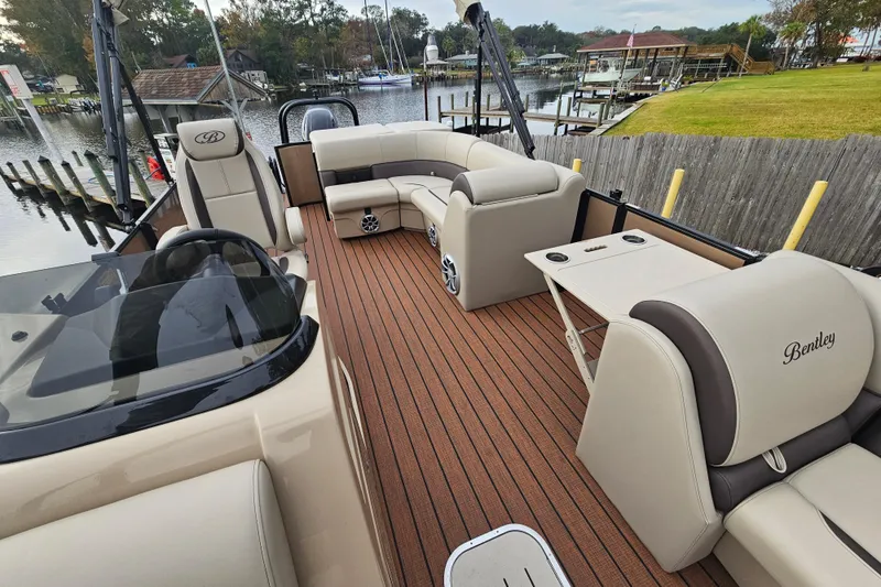 Slide: The Image of 2026 Bentley Pontoons Legacy 243 Cruise with luxurious seating and sleek design on a scenic dock. - 14