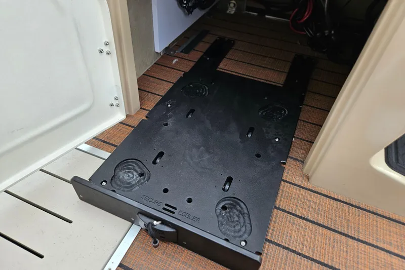 Slide: The Image of 2026 Bentley Pontoons Legacy 243 Cruise interior with secure cooler compartment. - 17