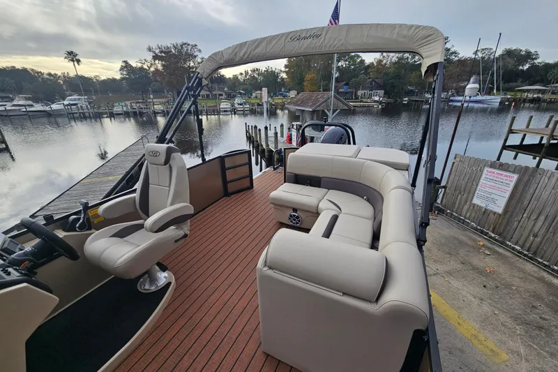 Slide: The Image of 2026 Bentley Pontoons Legacy 243 Cruise at a scenic dockside location. - 18