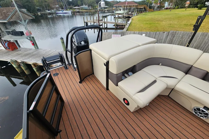 Slide: The Image of 2026 Bentley Pontoons Legacy 243 Cruise with luxurious seating, docked by a serene waterfront. - 19