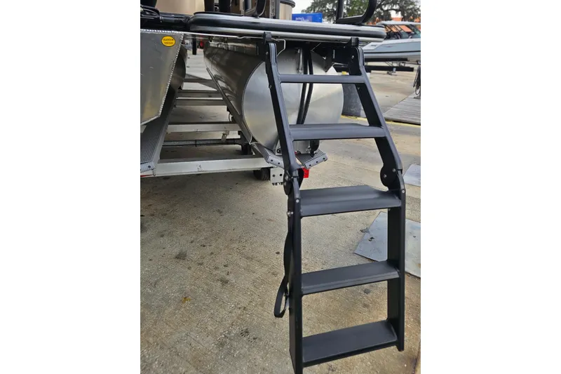 Slide: The Image of 2026 Bentley Pontoons Legacy 243 Cruise with boarding ladder on concrete surface. - 23