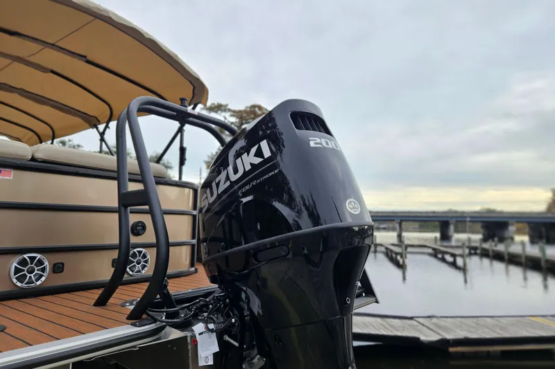 Slide: The Image of 2026 Bentley Pontoons Legacy 243 Cruise with Suzuki engine at a dockside view. - 3