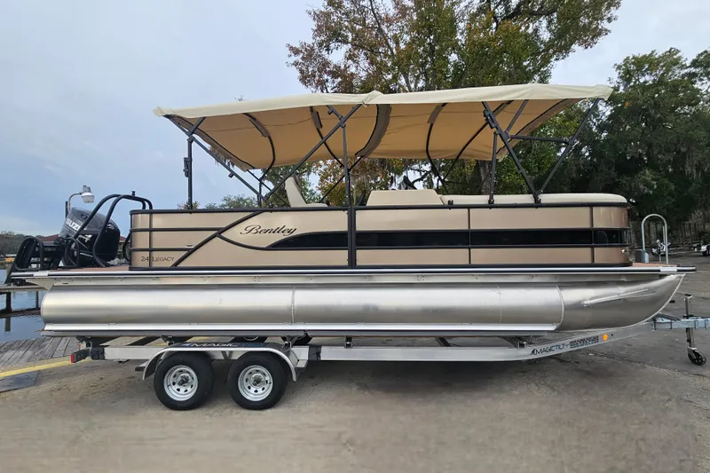 Slide: The Image of 2026 Bentley Pontoons Legacy 243 Cruise on trailer, featuring beige canopy and sleek design. - 6