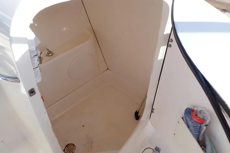 Slide: The Image of Interior of 2015 Pioneer 222 Venture boat, featuring storage compartment and fire extinguisher. - 11