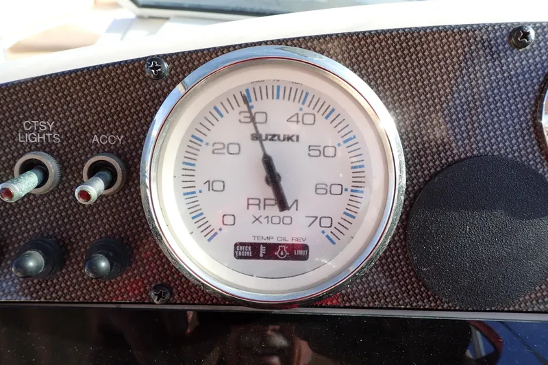 Slide: The Image of Close-up of a Suzuki RPM gauge on a 2015 Pioneer 222 Venture boat dashboard. - 13