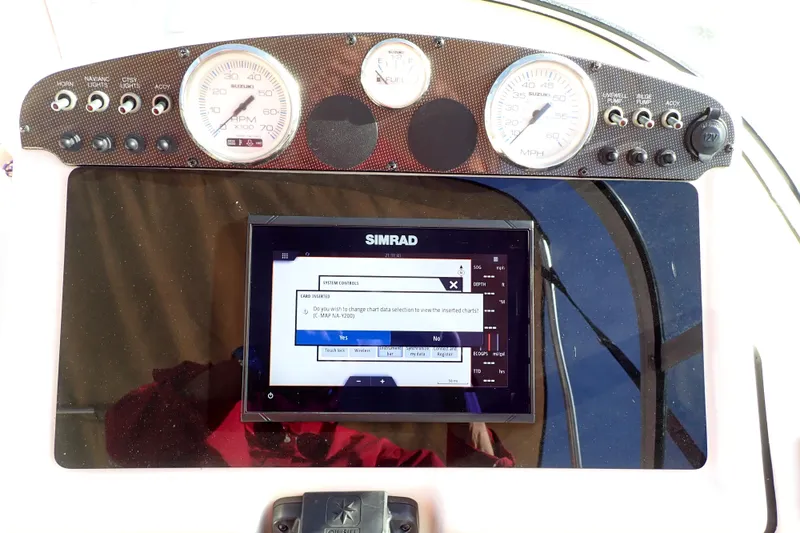 Slide: The Image of Dashboard of a 2015 Pioneer 222 Venture boat with Simrad navigation display. - 14