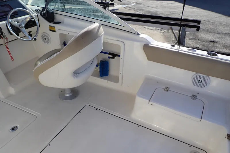 Slide: The Image of Interior of 2015 Pioneer 222 Venture boat with steering wheel and seating. - 15