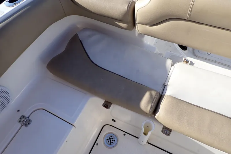 Slide: The Image of 2015 Pioneer 222 Venture boat interior with beige seating and white deck. - 26