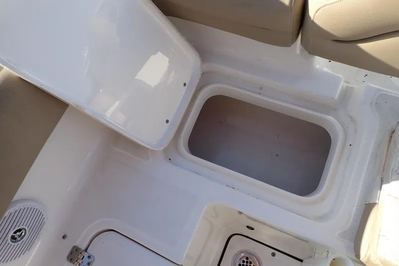 Slide: The Image of Open storage compartment on 2015 Pioneer 222 Venture boat interior. - 27