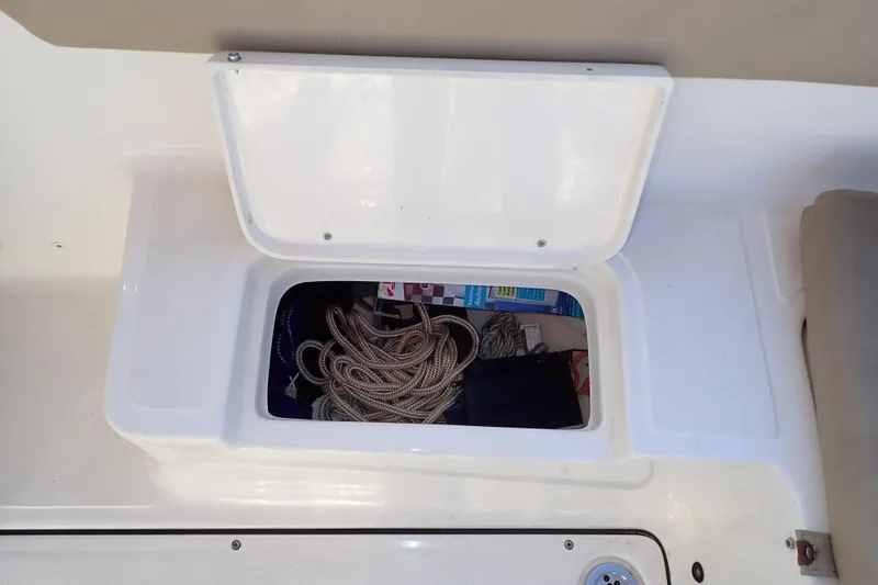 Slide: The Image of Open storage compartment on 2015 Pioneer 222 Venture boat with coiled rope inside. - 31