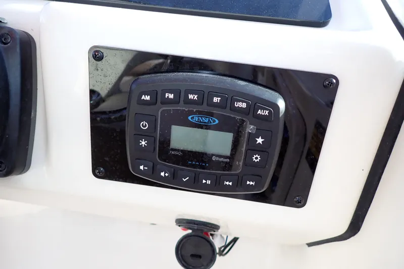 Slide: The Image of Jensen audio system on 2015 Pioneer 222 Venture boat dashboard, featuring multiple input options. - 34