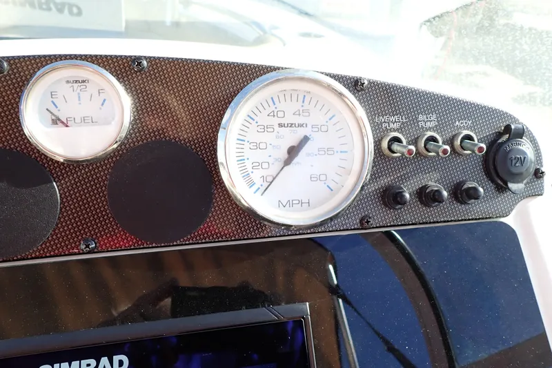 Slide: The Image of Dashboard of a 2015 Pioneer 222 Venture boat with gauges and switches. - 37