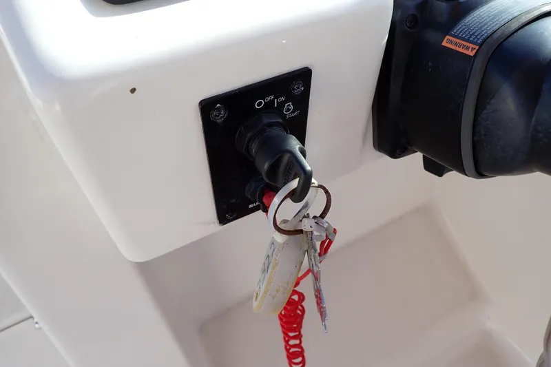 Slide: The Image of Ignition switch with keys on a 2015 Pioneer 222 Venture boat dashboard. - 39