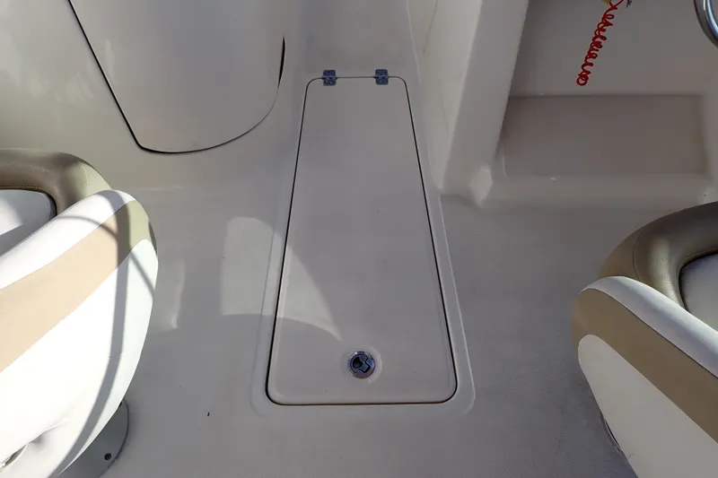 Slide: The Image of 2015 Pioneer 222 Venture boat interior with beige seating and storage compartment. - 40