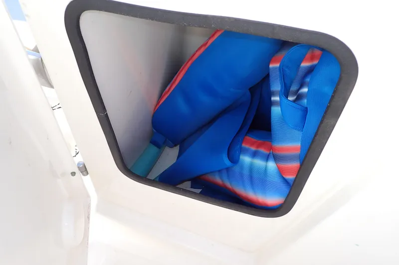 Slide: The Image of Storage compartment on 2015 Pioneer 222 Venture boat with colorful life jackets. - 43
