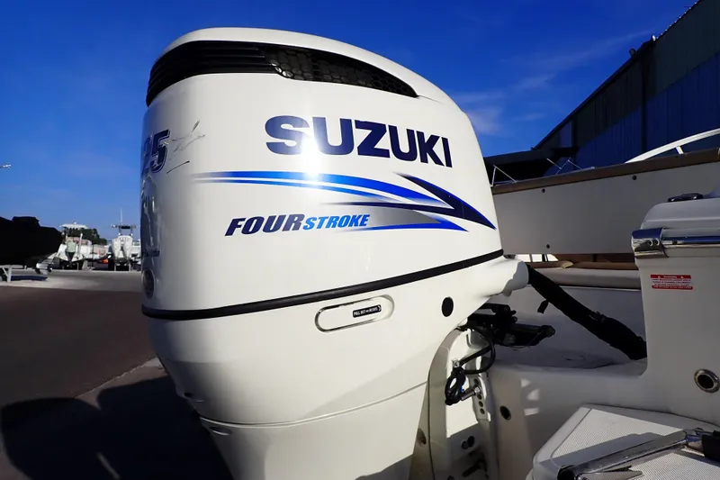 Slide: The Image of Suzuki Four Stroke engine on 2015 Pioneer 222 Venture boat, outdoor setting. - 53