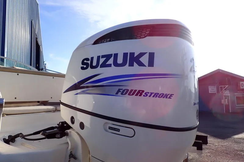 Slide: The Image of 2015 Pioneer 222 Venture boat with Suzuki four-stroke outboard motor in marina setting. - 59