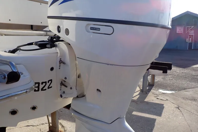 Slide: The Image of 2015 Pioneer 222 Venture boat engine close-up in a marina setting. - 60