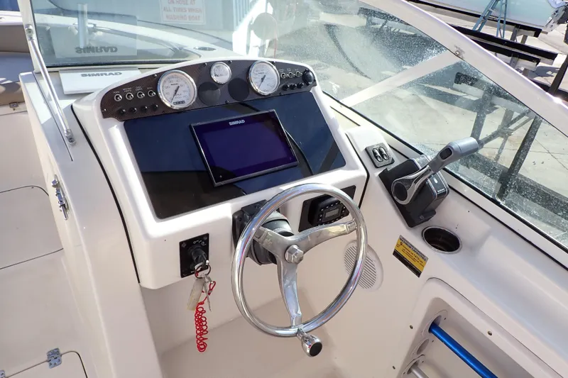 Slide: The Image of 2015 Pioneer 222 Venture boat dashboard with steering wheel and navigation controls. - 8