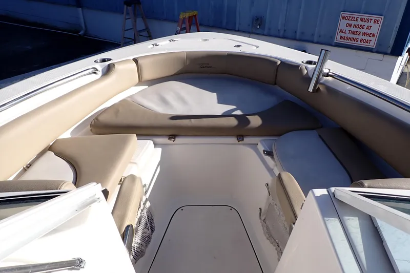 Slide: The Image of Interior view of 2015 Pioneer 222 Venture boat with beige seating and storage compartments. - 9