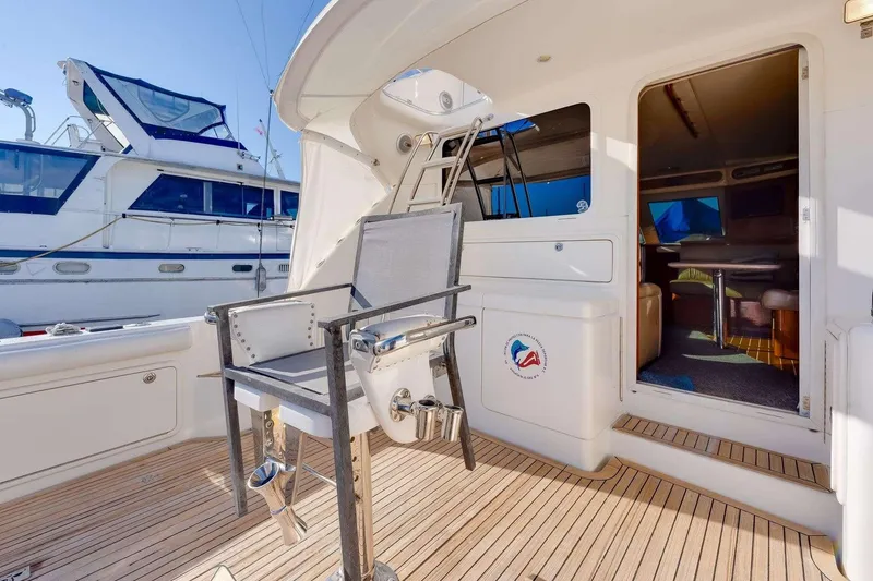 Slide: The Image of 2004 Riviera Convertible yacht interior with fishing chair and open cabin view. - 12