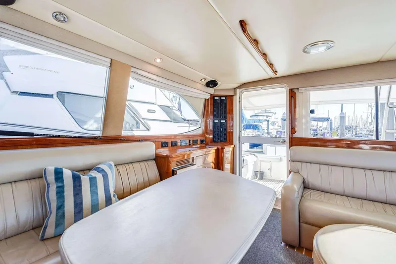 Slide: The Image of Luxurious interior of a 2004 Riviera Convertible yacht with leather seating and striped pillow. - 21