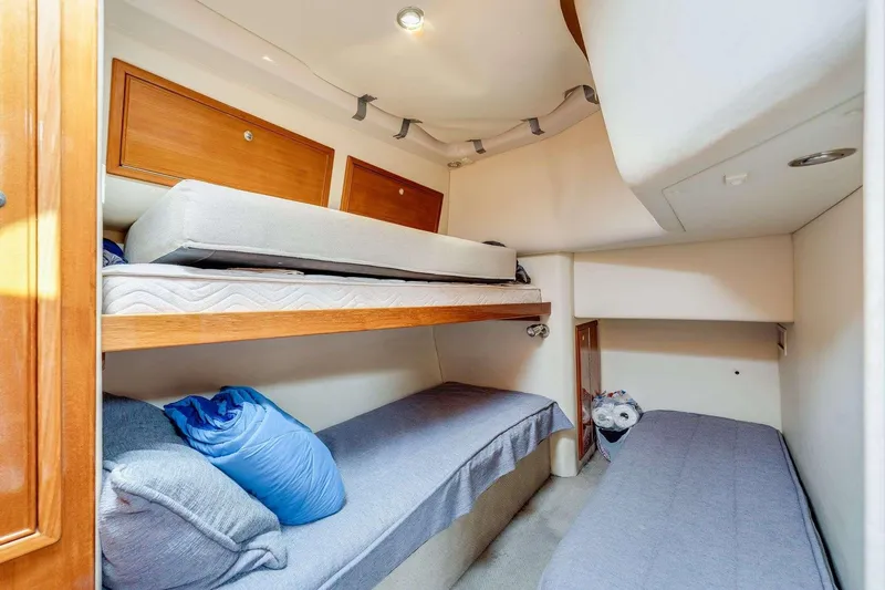 Slide: The Image of 2004 Riviera Convertible interior with cozy bunk beds and wooden storage cabinets. - 29