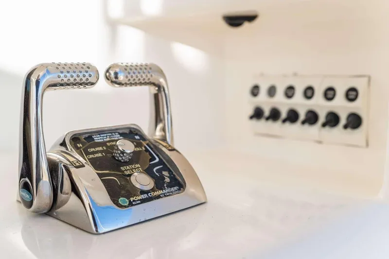 Slide: The Image of 2004 Riviera Convertible boat controls with chrome handles and switch panel. - 6