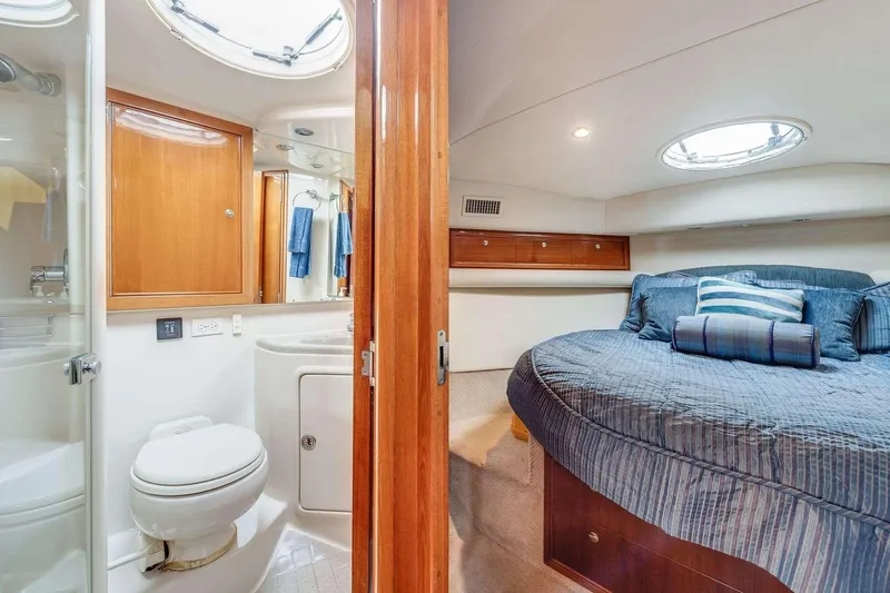 Slide: The Image of Luxurious 2004 Riviera Convertible yacht interior with cozy bedroom and modern bathroom. - 9