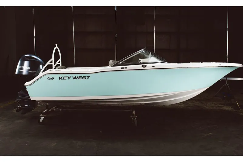 Slide: The Image of 2026 Key West 203 DFS boat interior with white seating and storage compartment. - 10