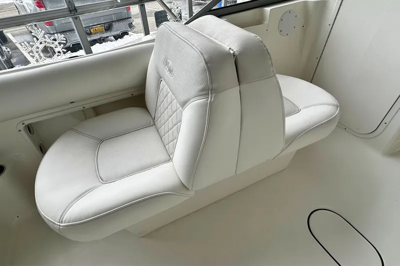 Slide: The Image of 2026 Key West 203 DFS boat interior with white cushioned seating. - 12
