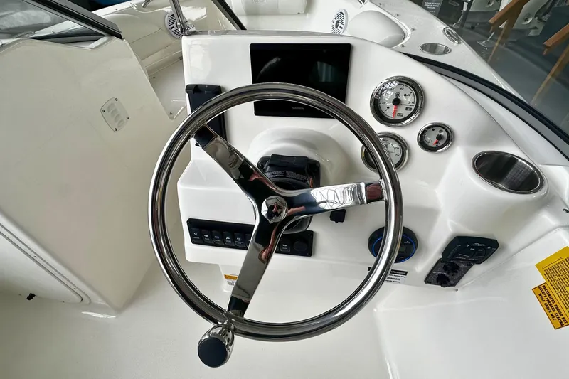 Slide: The Image of Steering console of 2026 Key West 203 DFS boat with gauges and controls. - 16