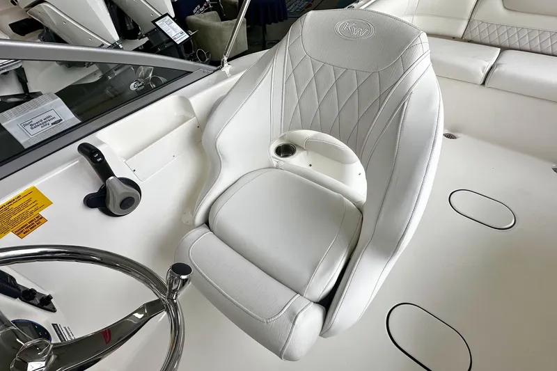 Slide: The Image of 2026 Key West 203 DFS boat interior with white captain's chair and steering wheel. - 18