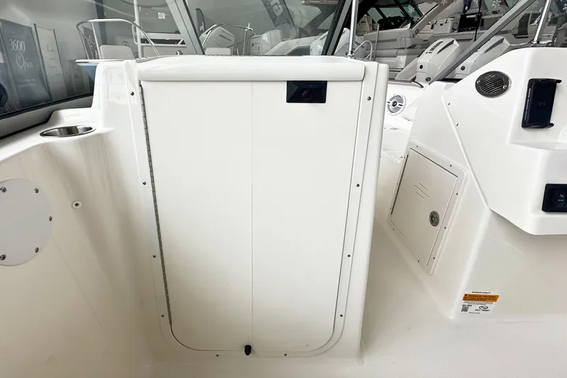 Slide: The Image of 2026 Key West 203 DFS boat interior, featuring white console and storage compartments. - 19