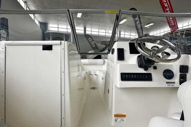 Slide: The Image of Interior view of 2026 Key West 203 DFS boat, featuring steering wheel and control panel. - 20