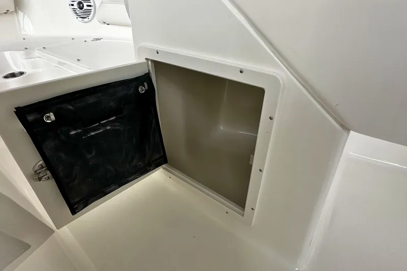 Slide: The Image of Open storage compartment on 2026 Key West 203 DFS boat interior. - 21