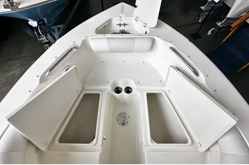 Slide: The Image of 2026 Key West 203 DFS boat interior with open storage compartments and sleek design. - 24