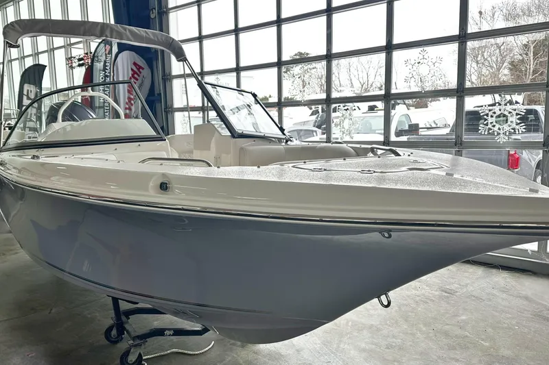 Slide: The Image of 2026 Key West 203 DFS boat in showroom, sleek design, large windows, winter-themed decor. - 25
